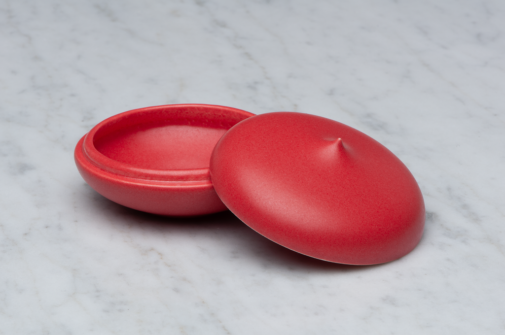 Toppig röd matt keramikask med locket på sidan